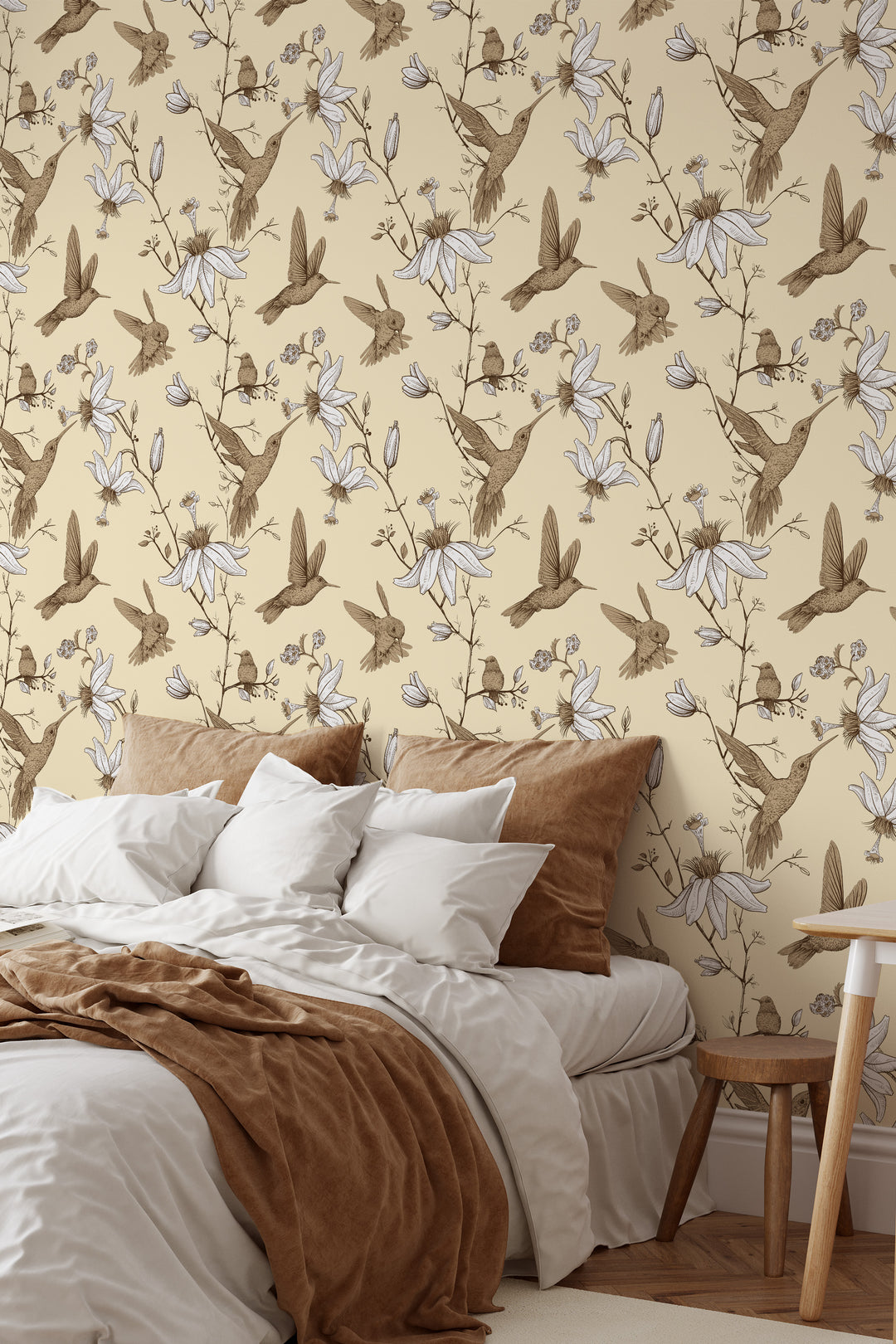 Bedroom featuring Hummingbird Wallpaper in cream with botanical floral bird pattern, cozy neutral bedding, and warm wood decor