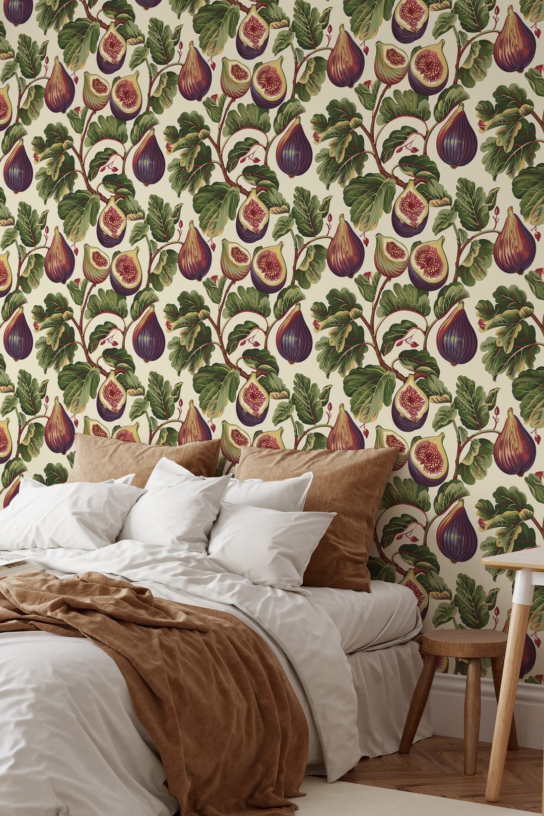 Cream fig wallpaper with a crimson-veined foliage pattern shown in a cozy bedroom.