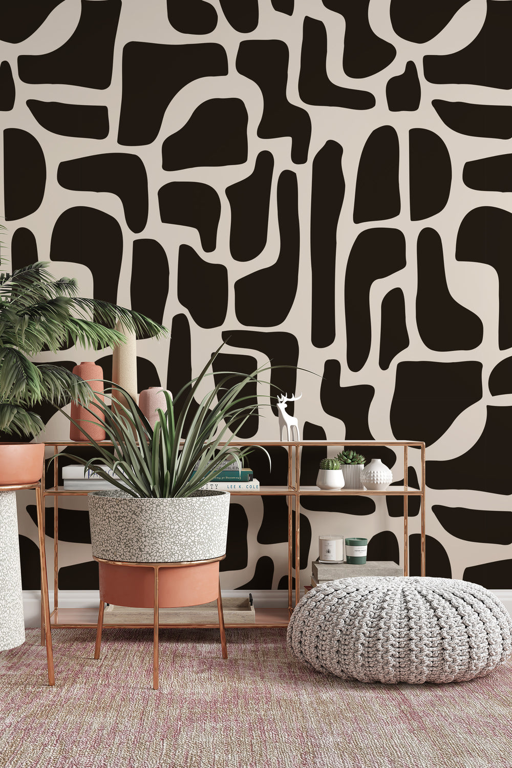 Black and beige abstract stone wallpaper with indoor plants, shelf, and cozy pouf