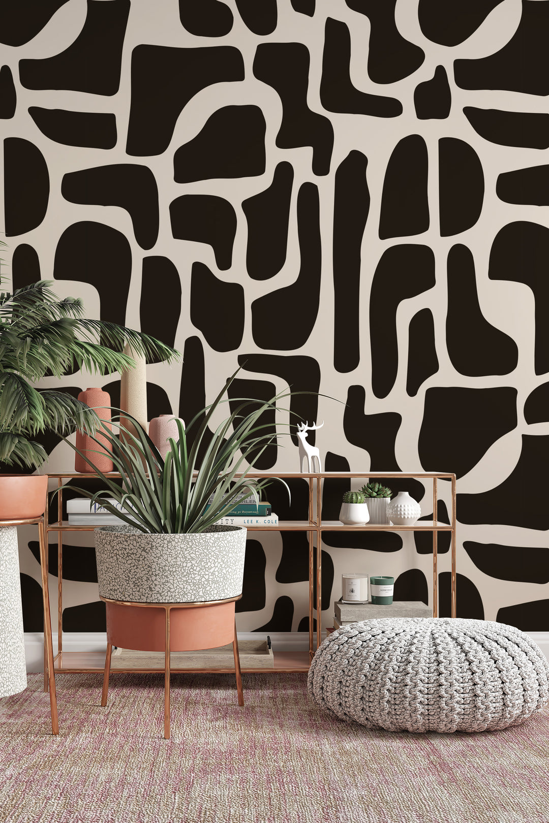 Black and beige abstract stone wallpaper with indoor plants, shelf, and cozy pouf