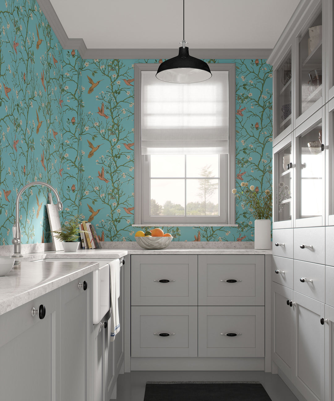 Aqua blue hummingbird wallpaper with flowering branches featured throughout a French-style kitchen with white cabinets and a central window.