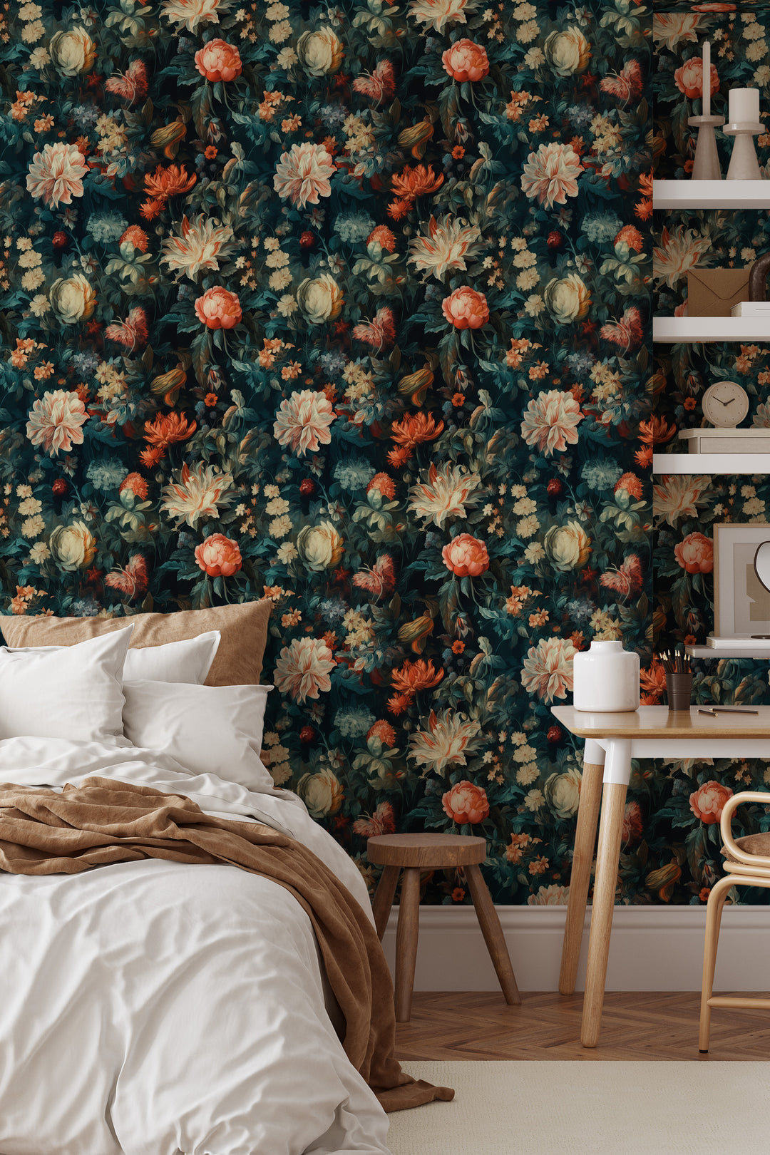 Cream and orange floral wallpaper on a dark teal background featured as a bedroom accent wall behind a bed, wooden desk, chair, and wall shelves.