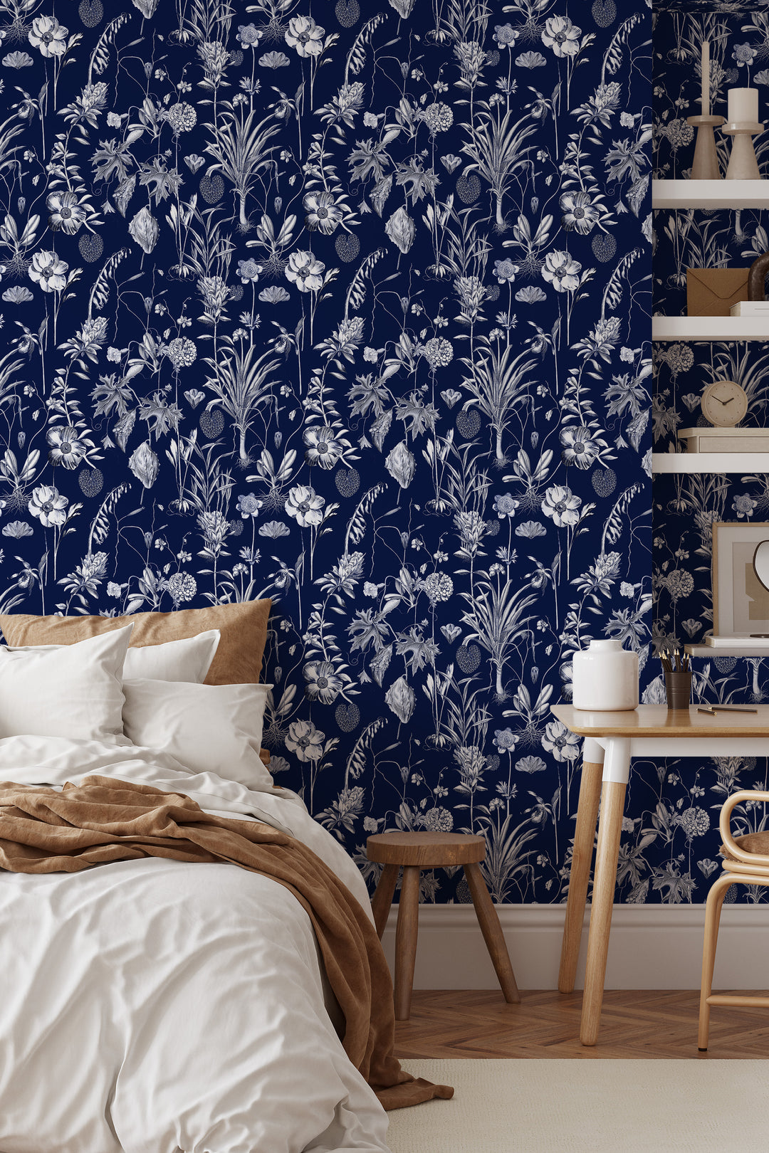 Midnight blue botanical toile wallpaper in bedroom with side table and shelf.
