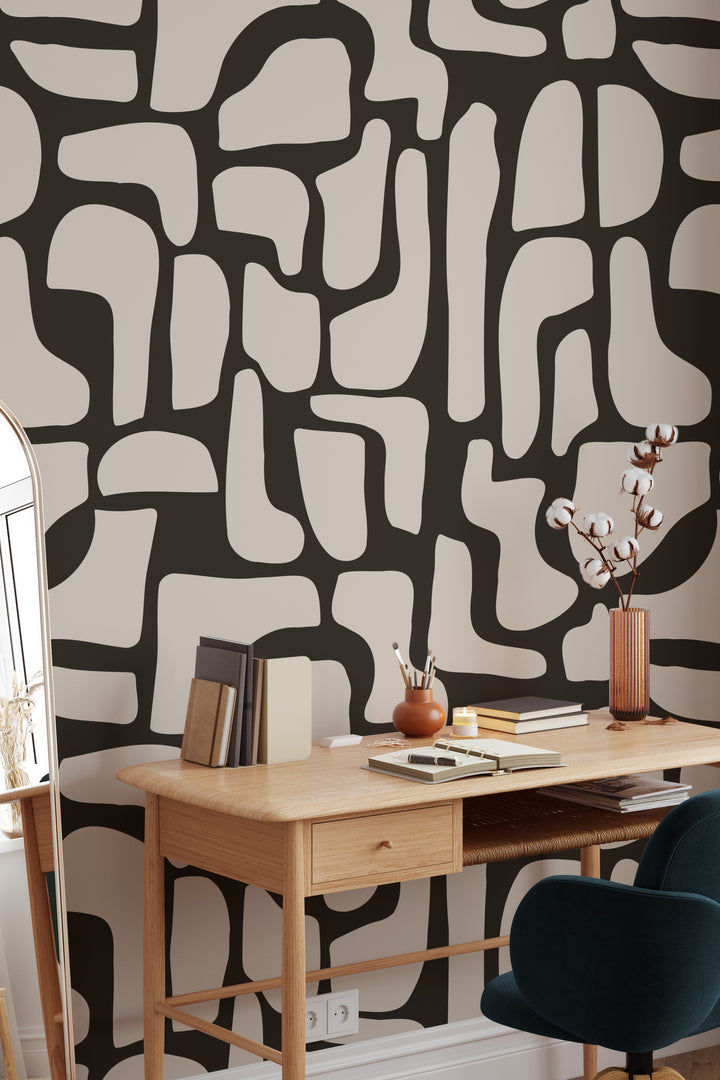 black and beige abstract stone wallpaper with wooden desk, chair, and cotton stems
