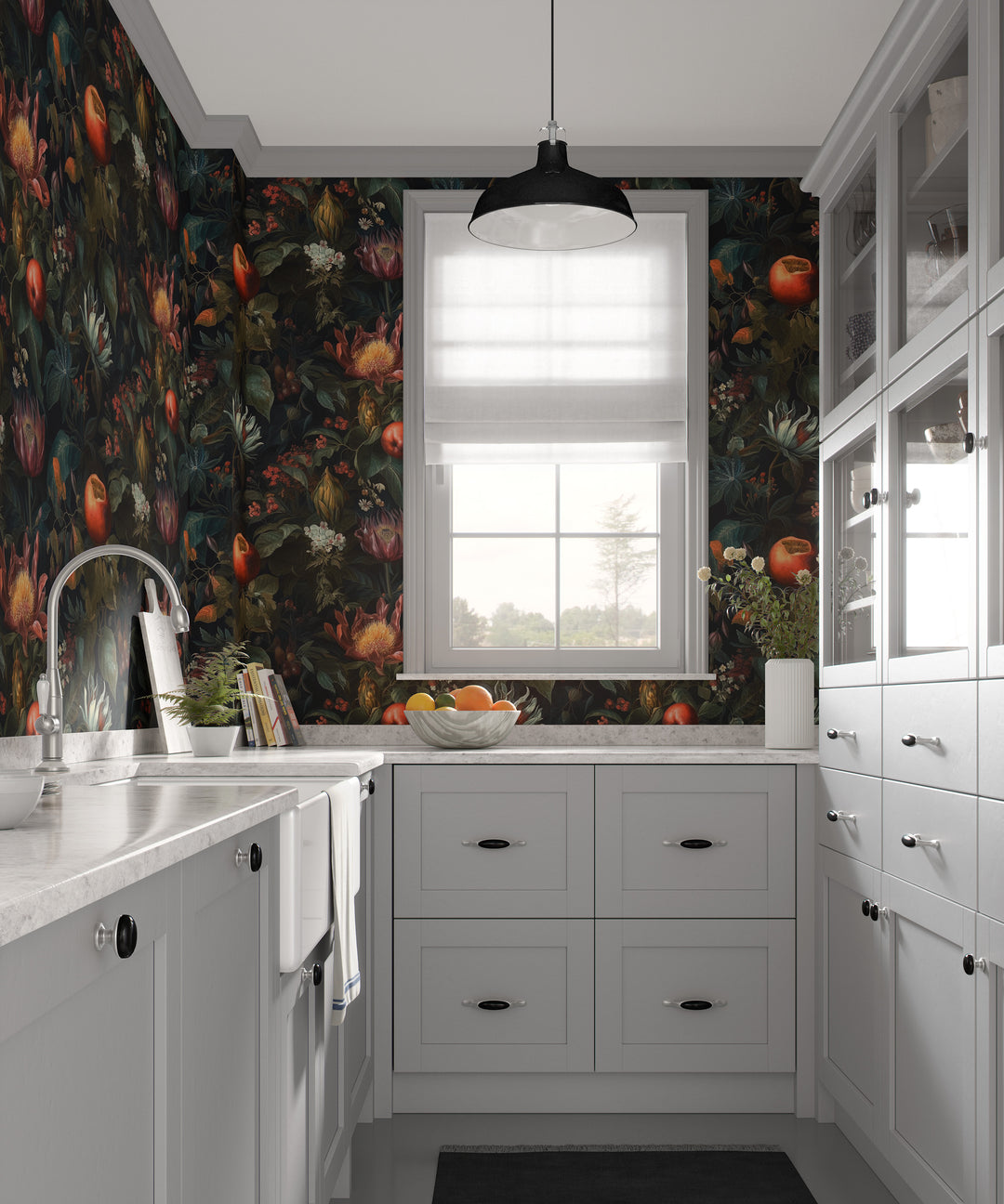 Dark botanical fruit wallpaper with red and orange flowers and foliage in a bright white kitchen with cabinets, countertops, and a window.