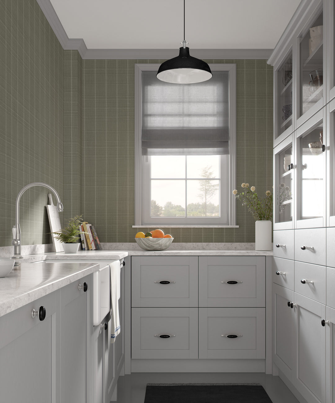 Sage gray Varrone canvas wallpaper with a subtle windowpane grid pattern covering the walls of a classic kitchen with white cabinetry, marble countertops, and a black pendant light.