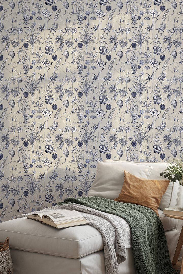 Blue and white floral wallpaper on a beige background with sofa, pillows, and blanket