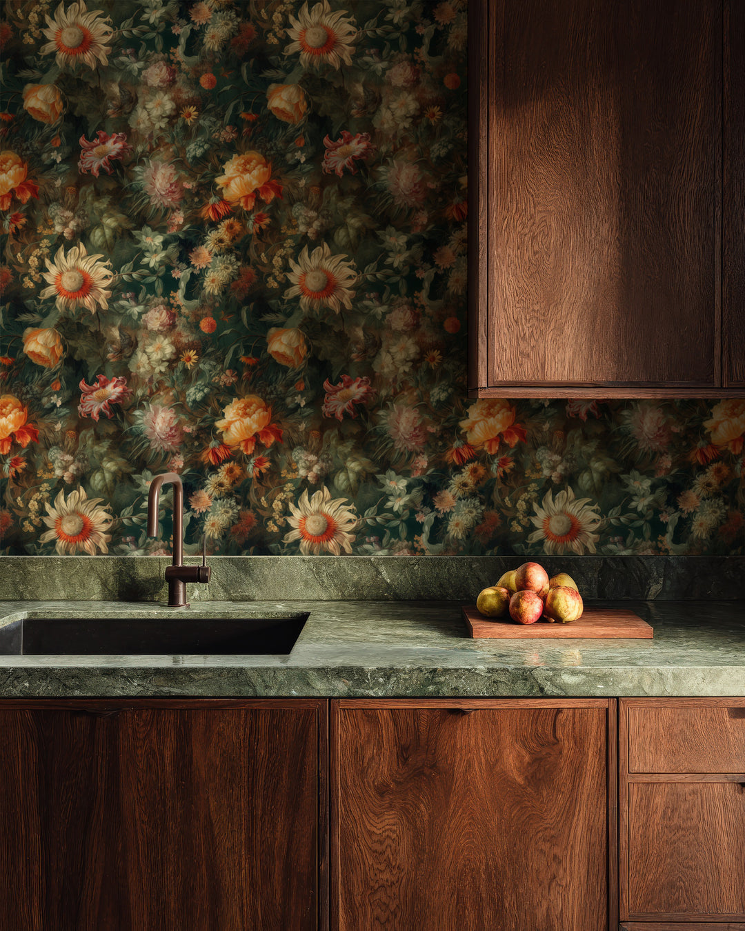 Warm orange and cream vintage floral wallpaper featuring layered flowers and lush greenery, styled as a dramatic kitchen backsplash with dark wood cabinetry, a green stone countertop, and warm rustic accents.