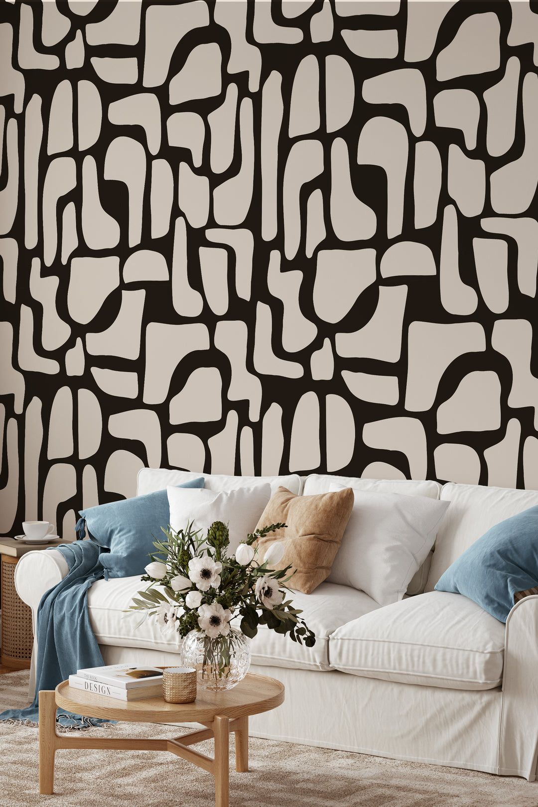 Black and beige abstract stone wallpaper with sofa, pillows, and coffee table