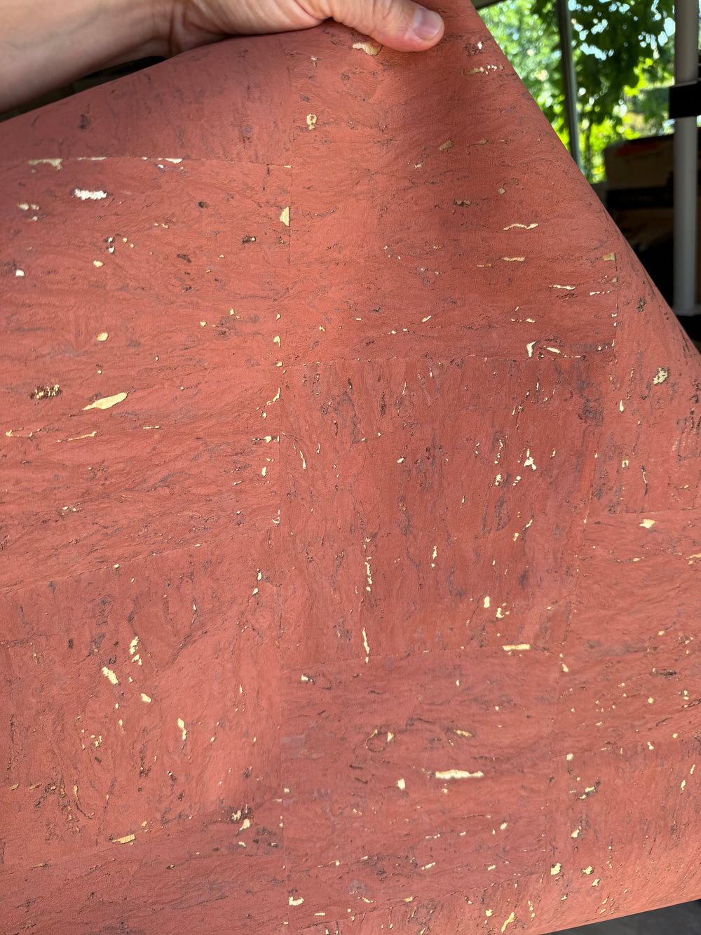 Close-up of a pink cork with gold specks held by a hand