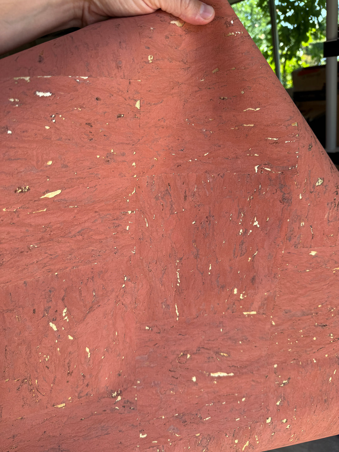 Close-up of a pink cork with gold specks held by a hand