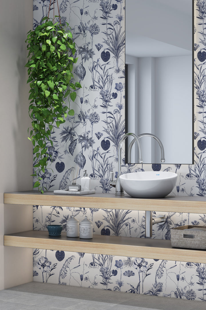 Blue botanical toile white wallpaper with bathroom sink, mirror, and hanging plant
