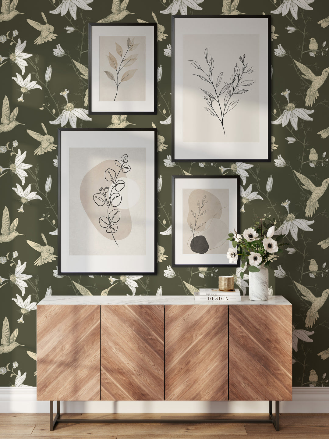 Living room with olive green hummingbird wallpaper featuring a botanical floral bird pattern, framed botanical artwork, and modern wood console decor