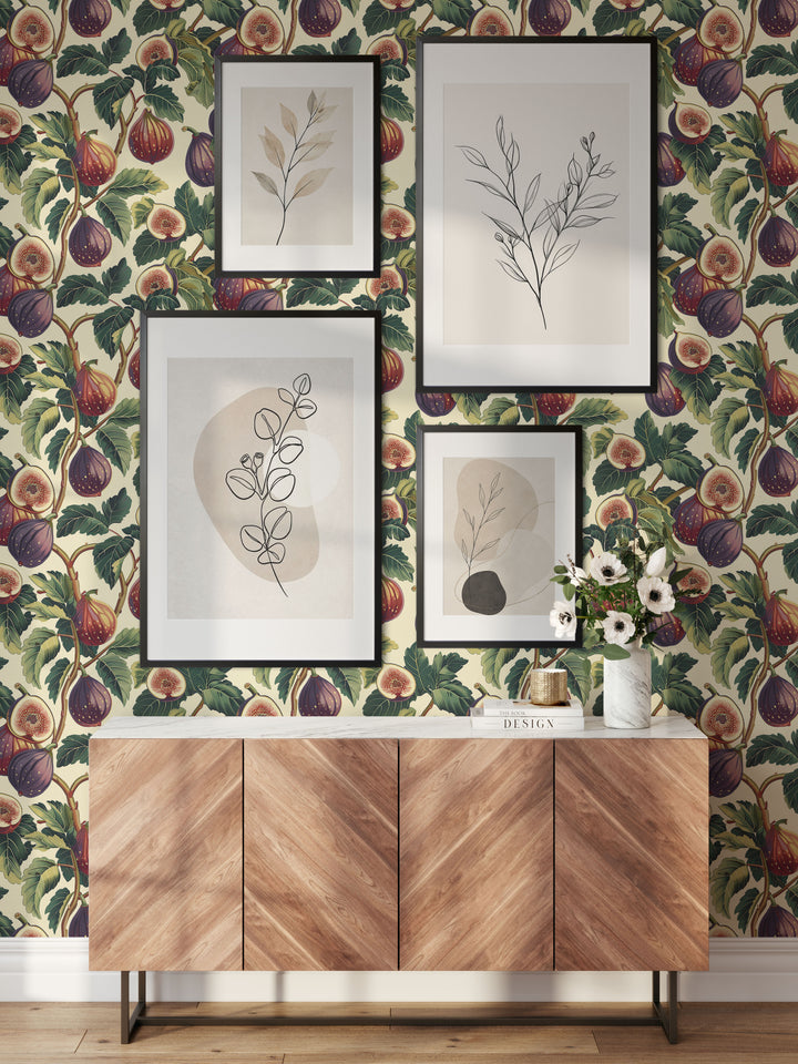 Cream fig and leaf wallpaper with a purple speckled vintage botanical pattern shown in a modern interior with framed artwork.