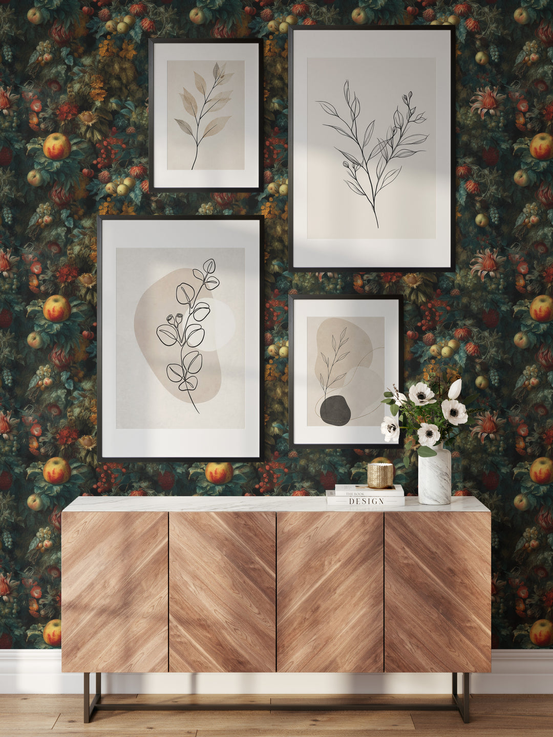 Vintage dark teal and orange botanical wallpaper with fruit and flowers behind a wooden sideboard and framed botanical prints.