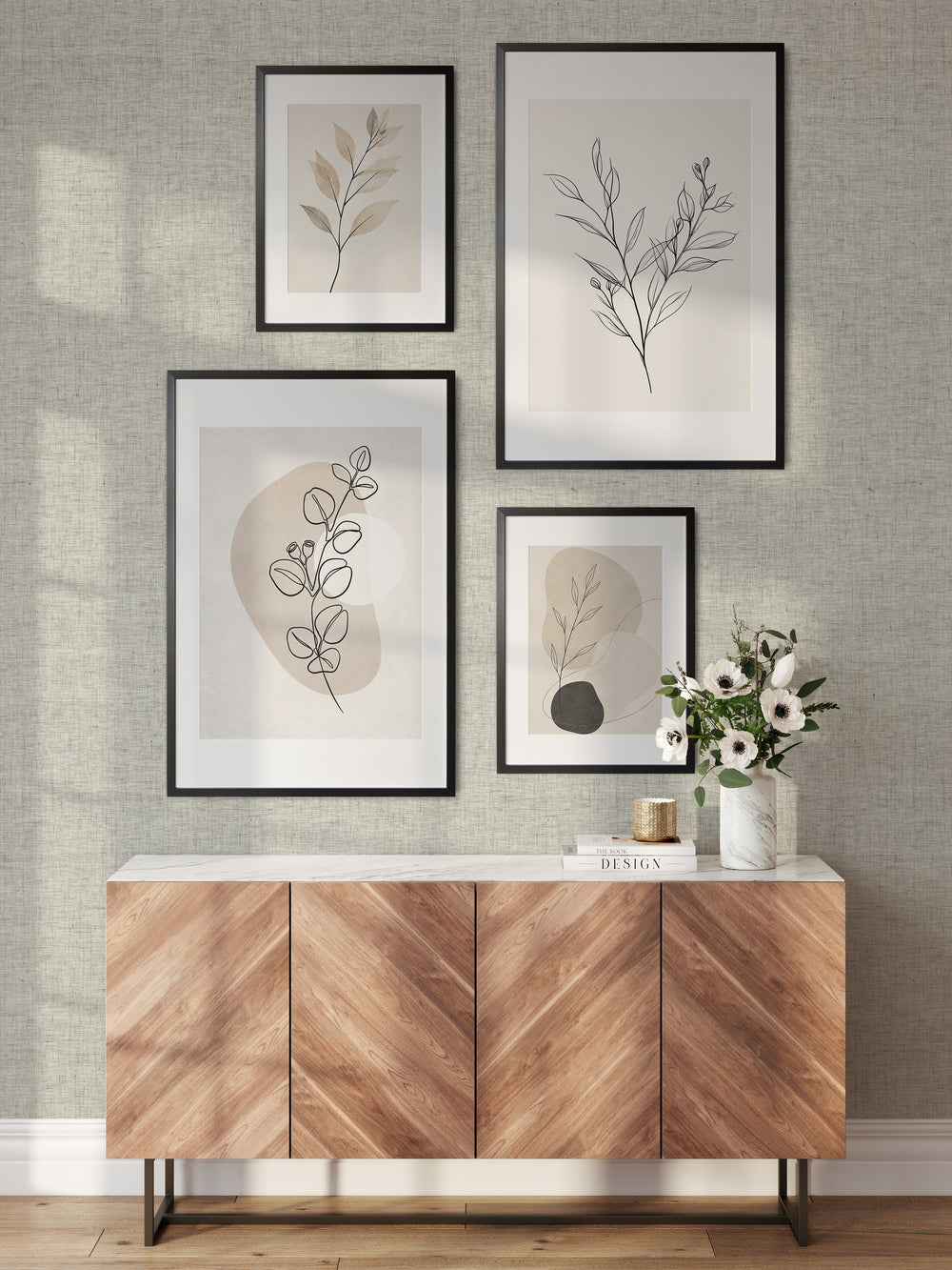 Ivory faux linen wallpaper with an open woven texture behind a wooden sideboard, complemented by framed botanical prints, a white floral arrangement, and warm natural wood accents.