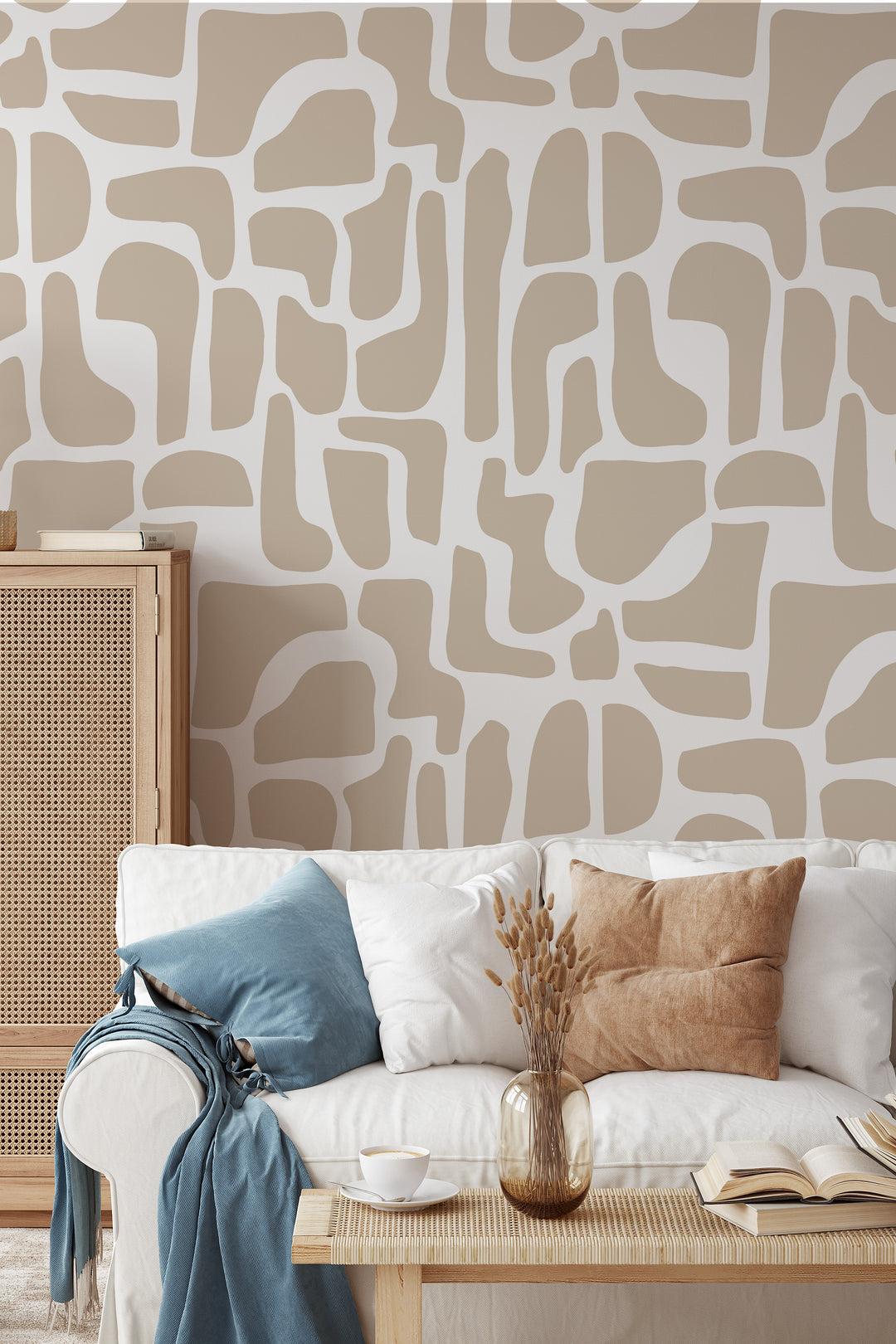 Beige and white abstract stone wallpaper in living room with sofa, pillows, and coffee table