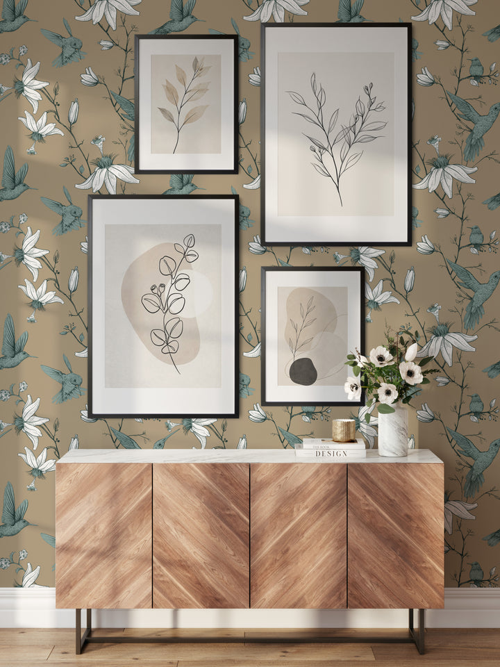 Cozy living room with a wood sideboard and picture frames featuring cream hummingbird wallpaper with a vintage botanical floral bird pattern.