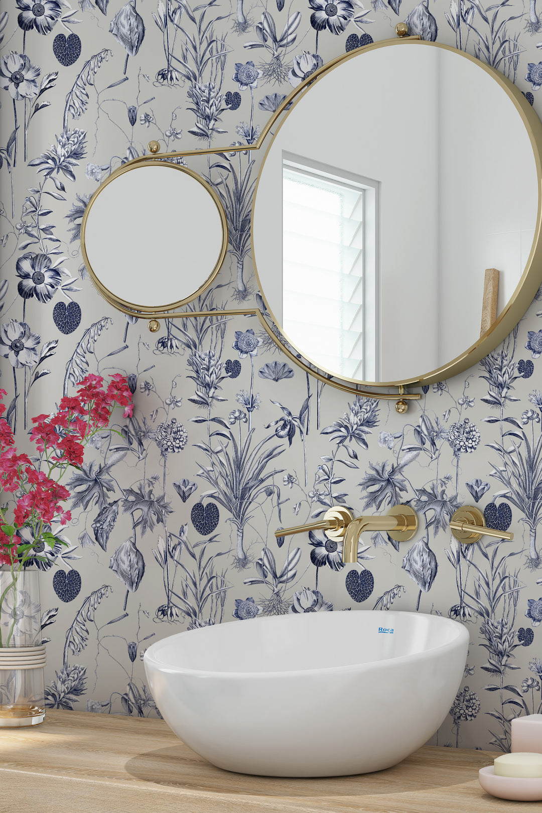 Blue and white floral wallpaper on a beige background with bathroom sink and mirror
