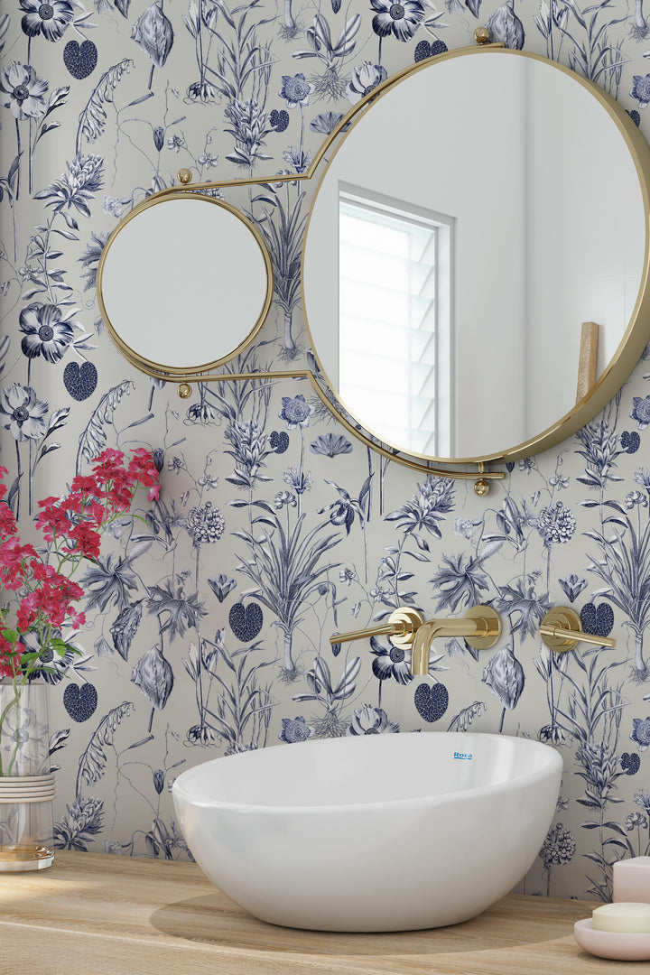 Blue and white floral wallpaper on a beige background with bathroom sink and mirror