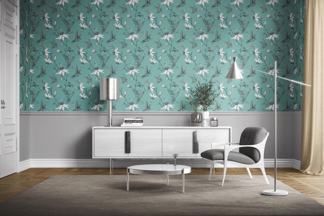 Modern living room with a white sideboard and lounge chair featuring Aqua Green Hummingbird Wallpaper with a floral bird pattern.