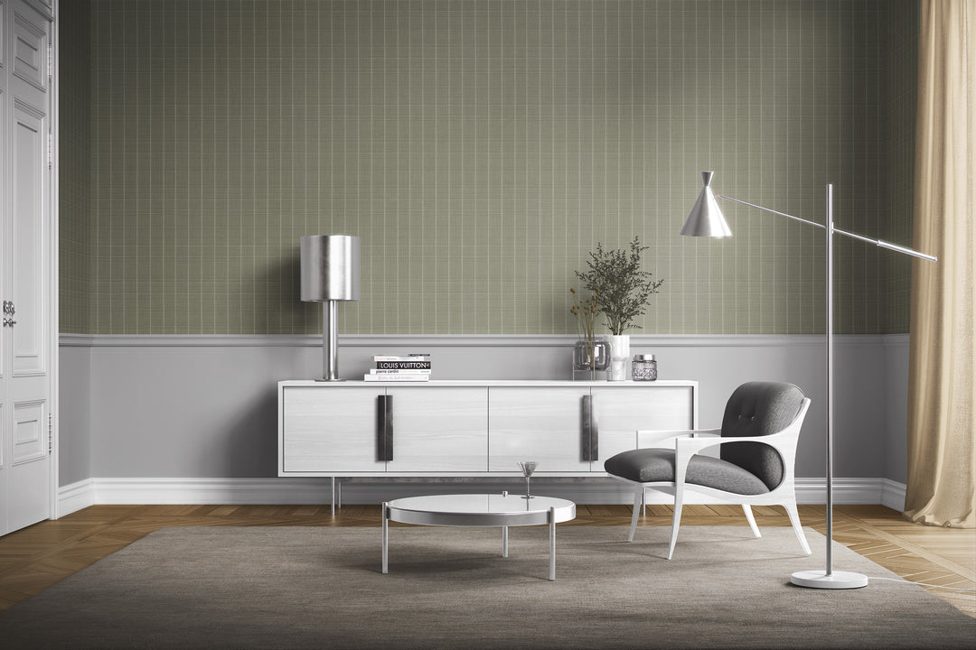 Sage gray Varrone canvas wallpaper with a subtle windowpane grid pattern in a modern living room featuring a white sideboard, gray upholstered accent chair, and sleek metallic lighting.