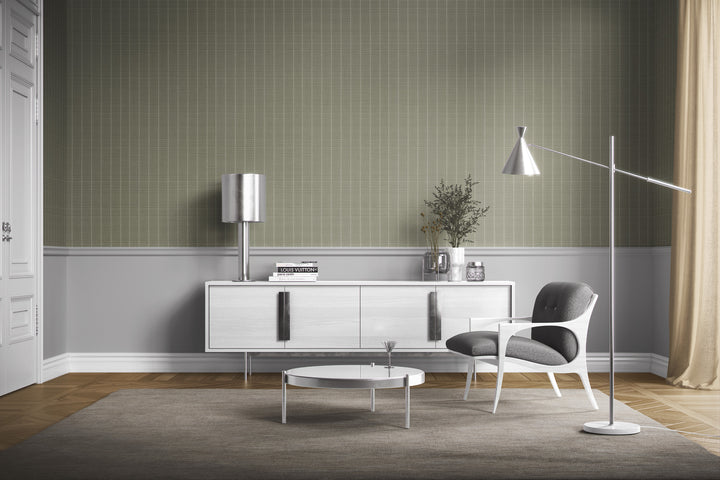 Sage gray Varrone canvas wallpaper with a subtle windowpane grid pattern in a modern living room featuring a white sideboard, gray upholstered accent chair, and sleek metallic lighting.