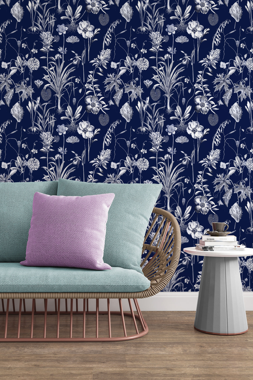 Midnight blue botanical toile wallpaper in living room with sofa, pillows, and side table