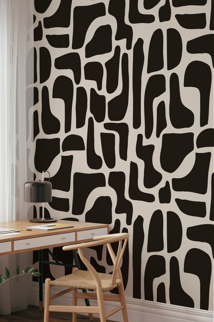 Black and beige abstract stone wallpaper with desk, chair, and curtain