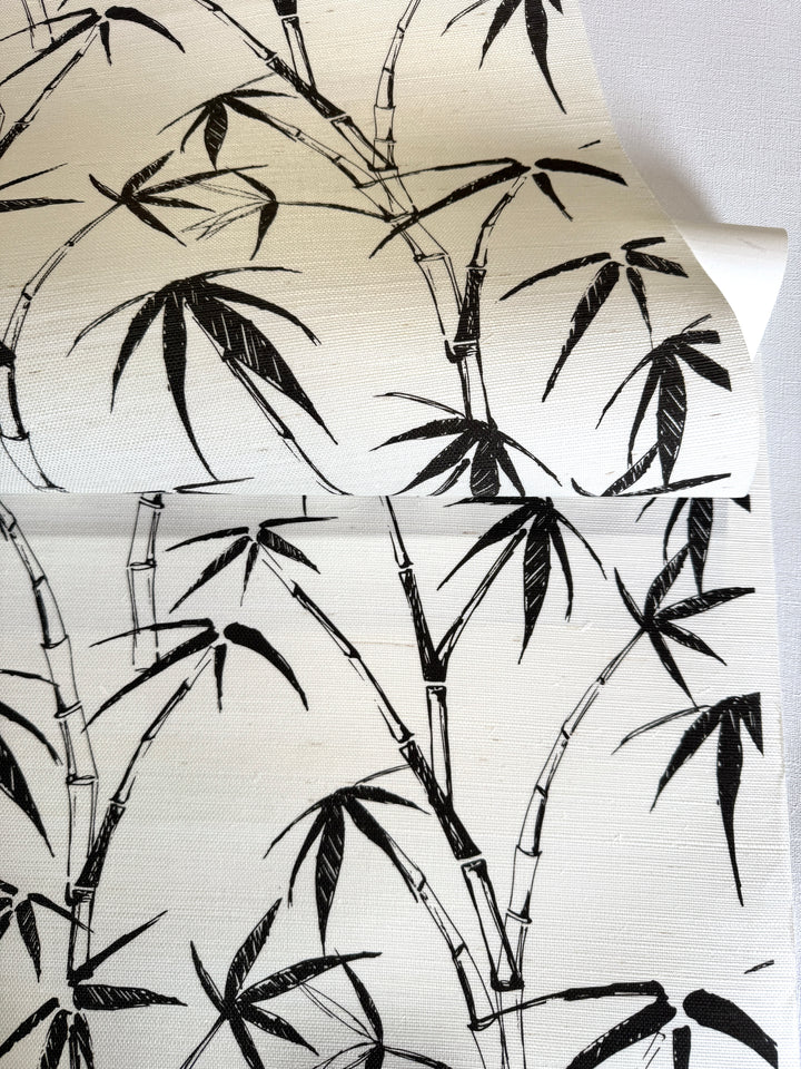 Natural printed sisal grasscloth wallpaper with hand-drawn bamboo pattern, black ink illustration on real woven grasscloth texture, close-up view showing organic fiber surface