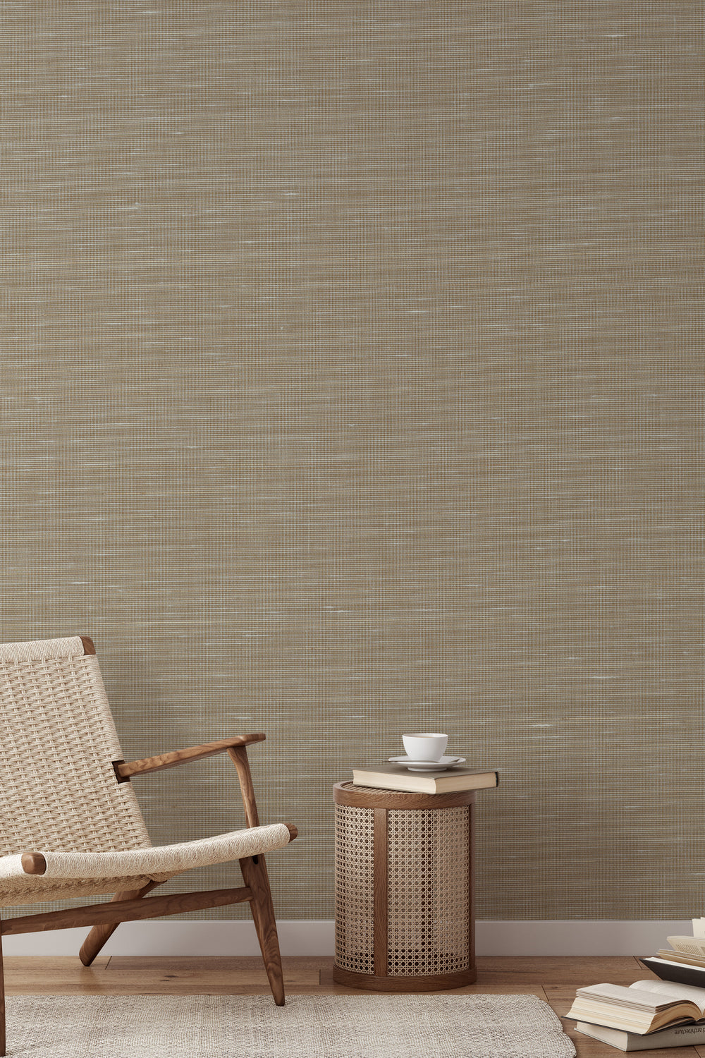 Woven armchair with a book on soft beige faux abaca grasscloth wallpaper.