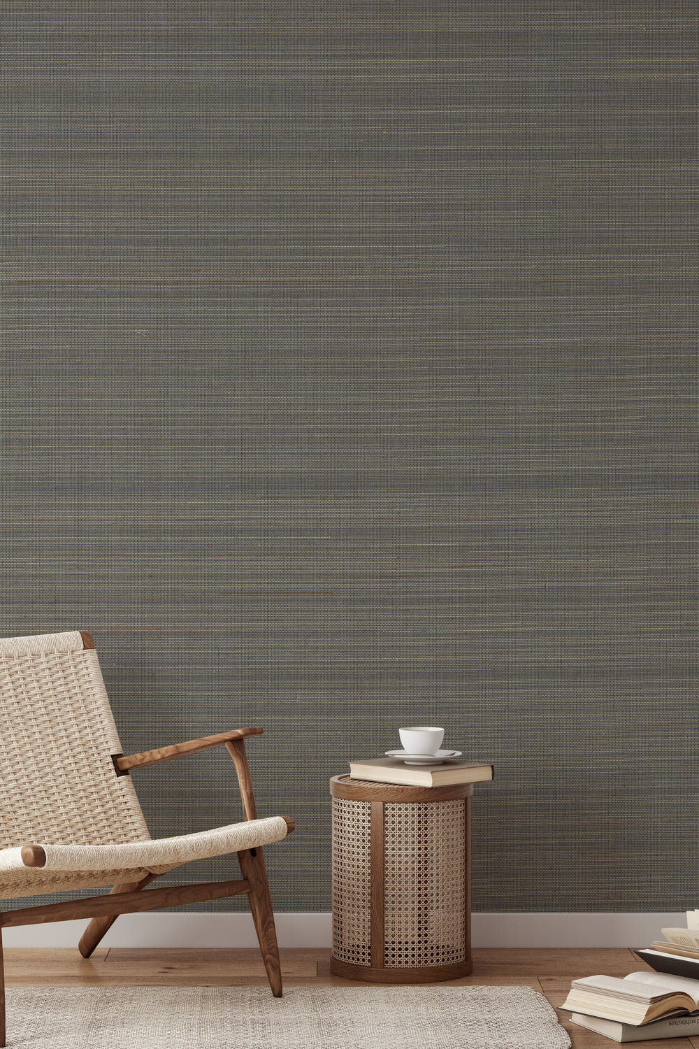 Woven wooden armchair with a book on soft gray-beige faux abaca grasscloth wallpaper.