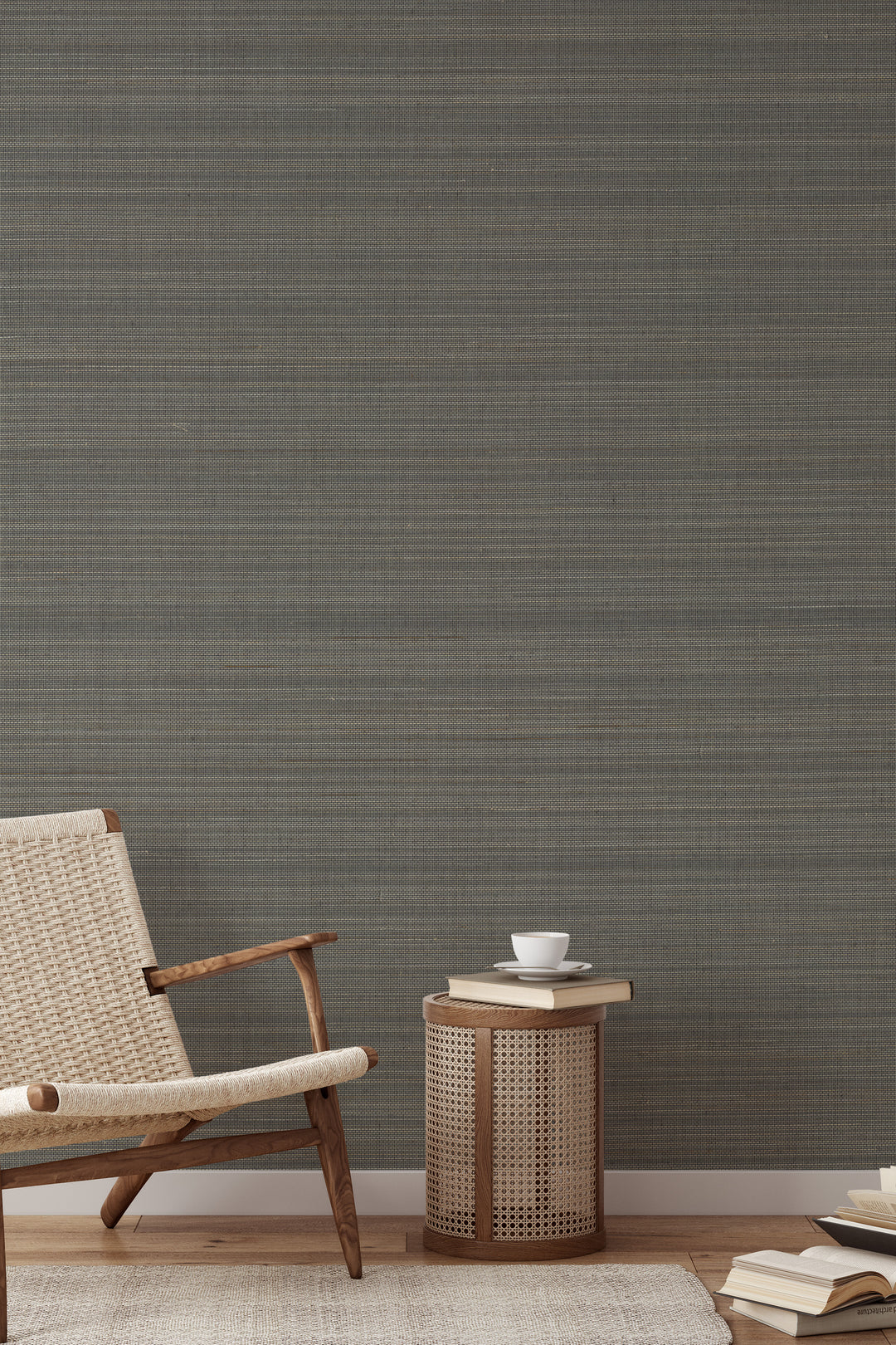 Woven wooden armchair with a book on soft gray-beige faux abaca grasscloth wallpaper.