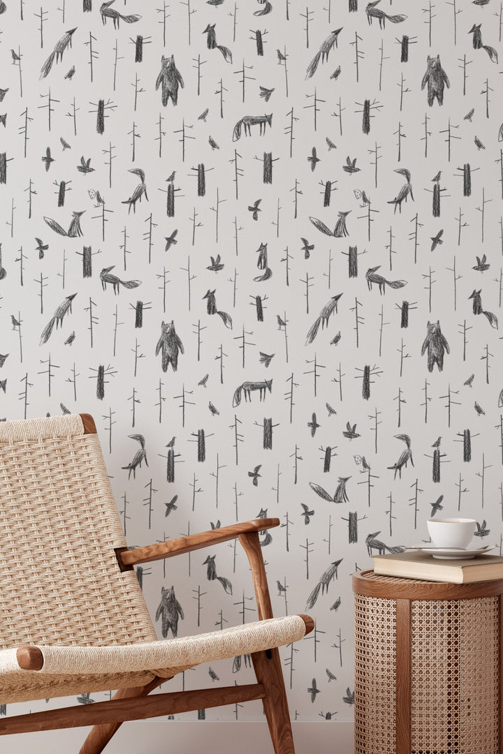 Wallpaper with animal pattern on a wall with a chair and table.