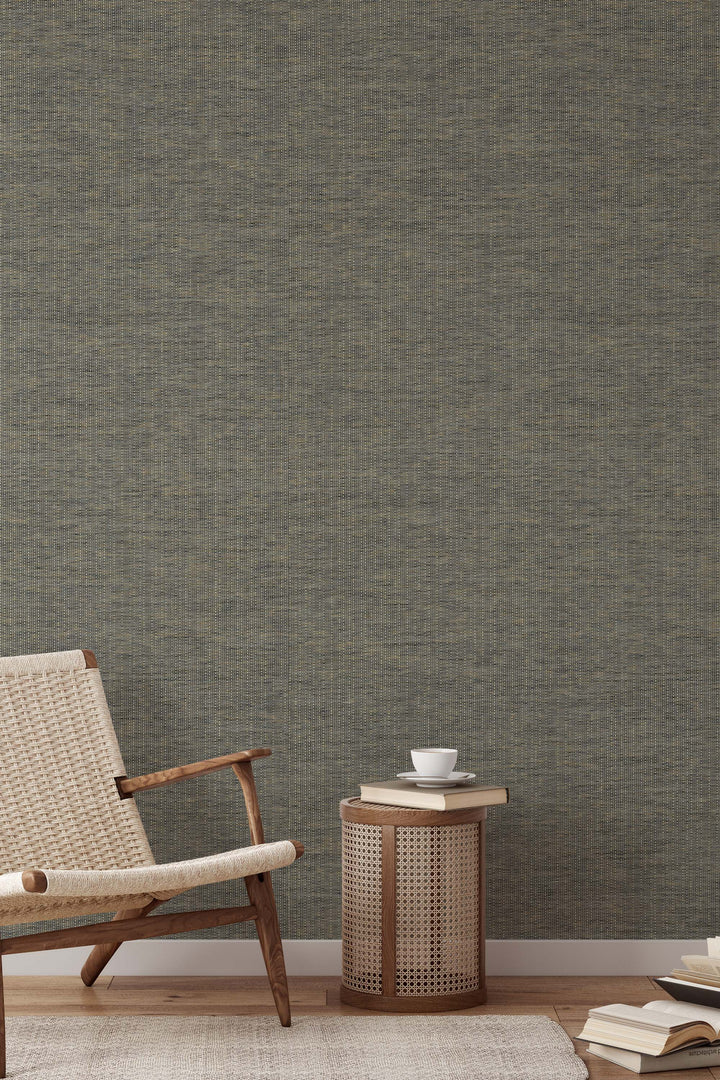Textured commercial wallpaper with a chair and small table in front