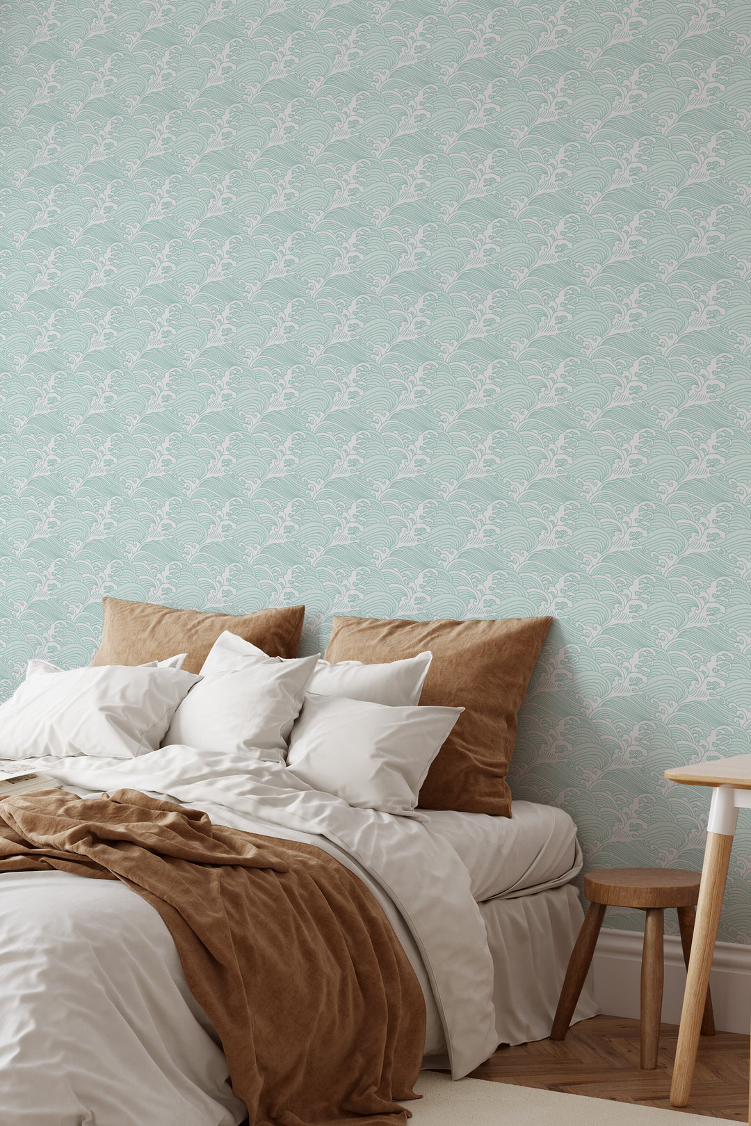 Bedroom with light aqua Japanese wave wallpaper featuring a traditional ocean pattern and warm neutral decor