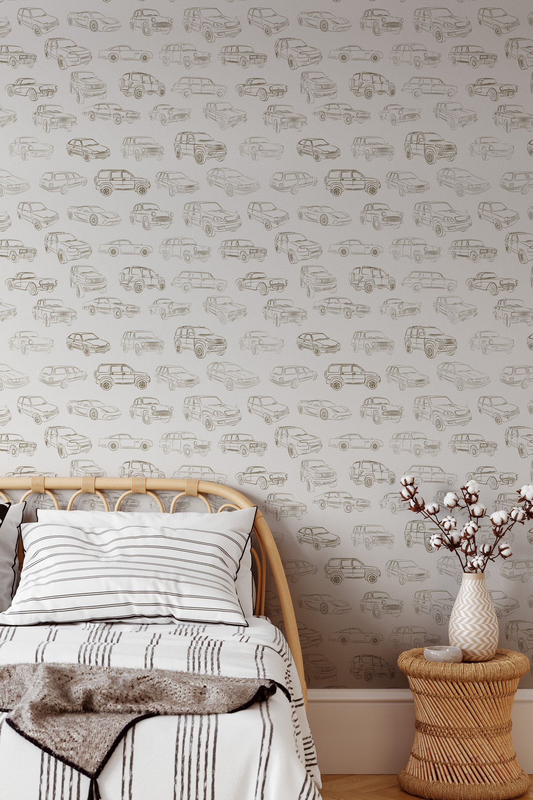 Neutral vintage car wallpaper with brown line art vehicle illustrations in a cozy modern bedroom with rattan furniture
