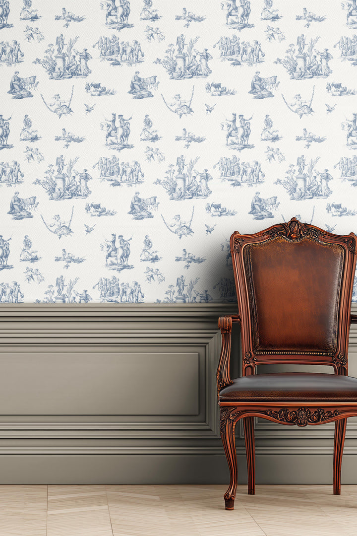 Vintage French blue toile wallpaper with pastoral scenes on ivory background installed behind a classic wooden chair