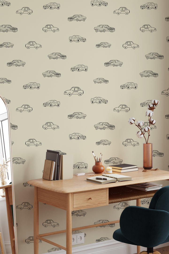 Home office with beige vintage car wallpaper, black line art vehicle pattern, wooden desk, and modern chair