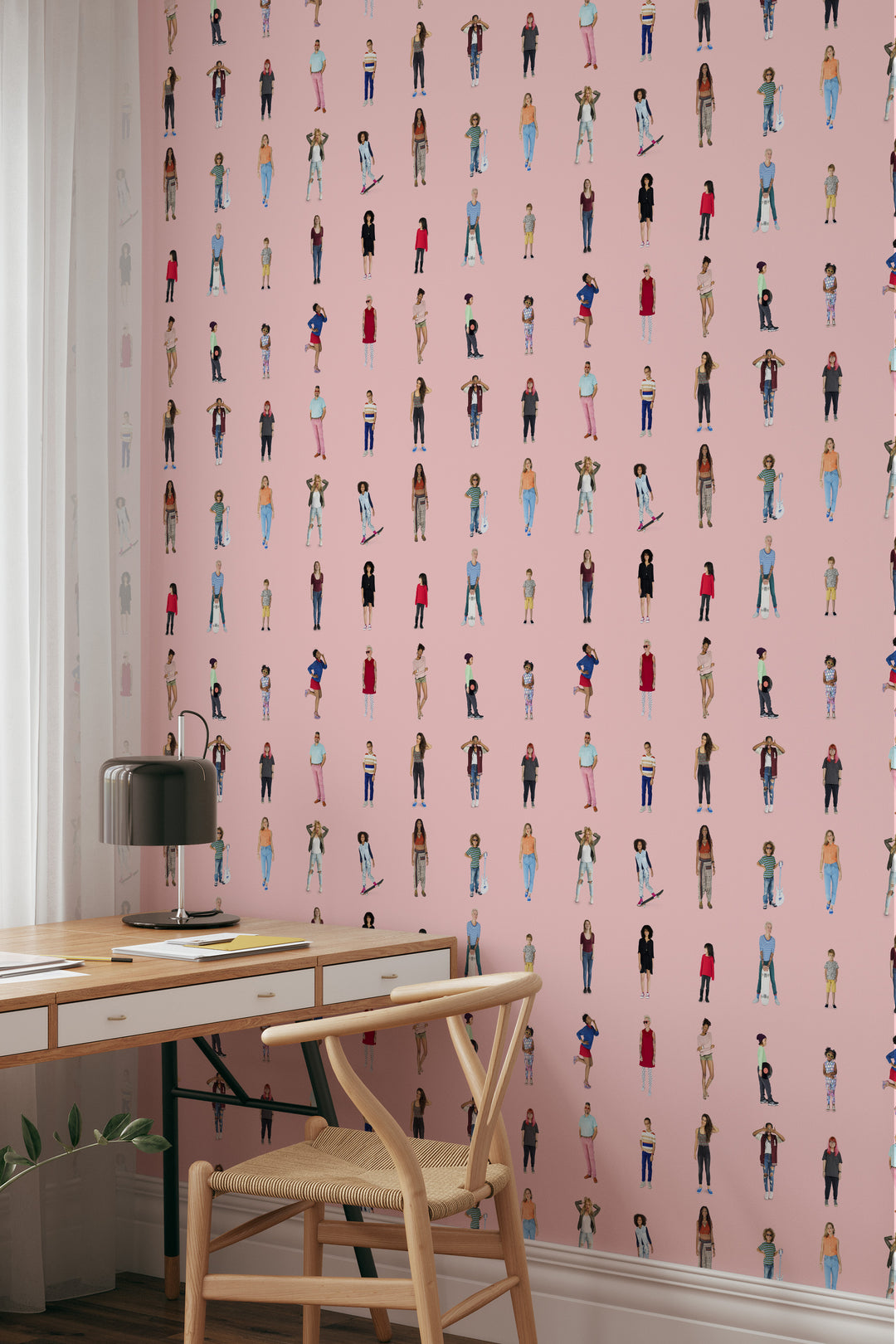 Home office with soft pink cutout people wallpaper, playful character pattern, wooden desk, and modern chair