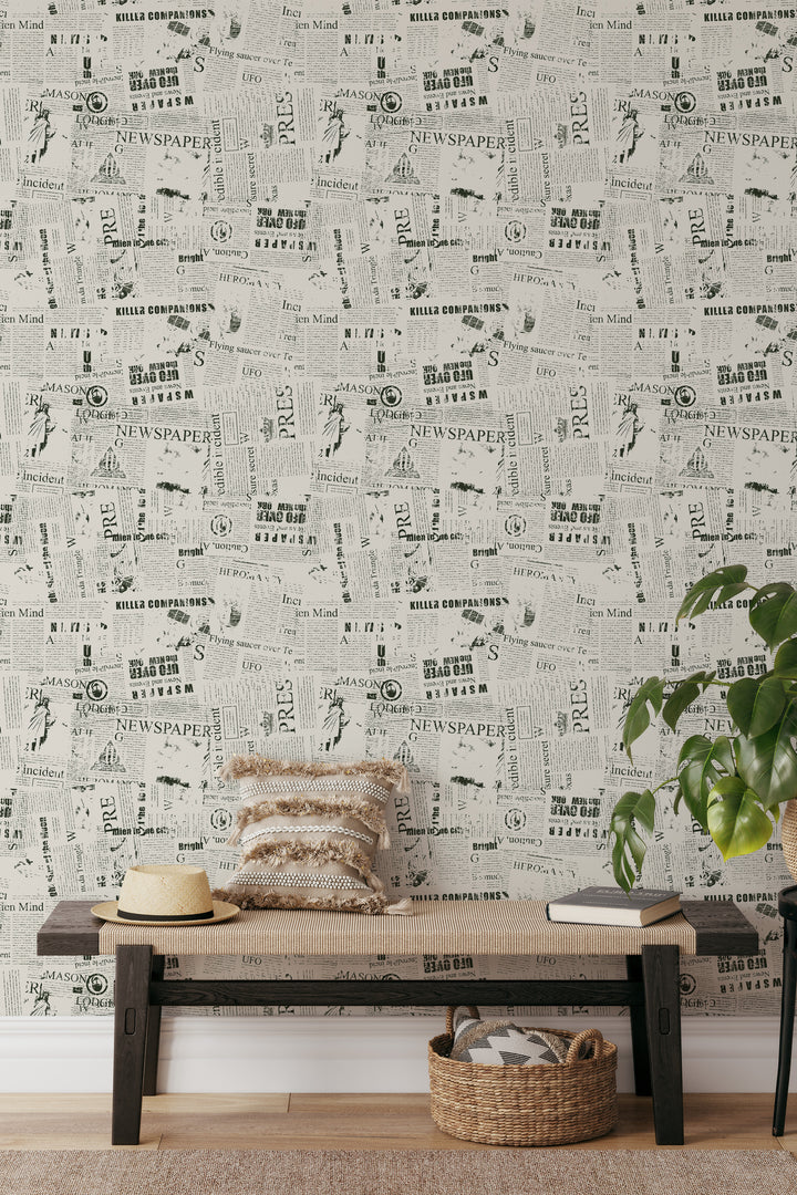 Living room with vintage newspaper collage wallpaper in black and white print and cozy neutral decor