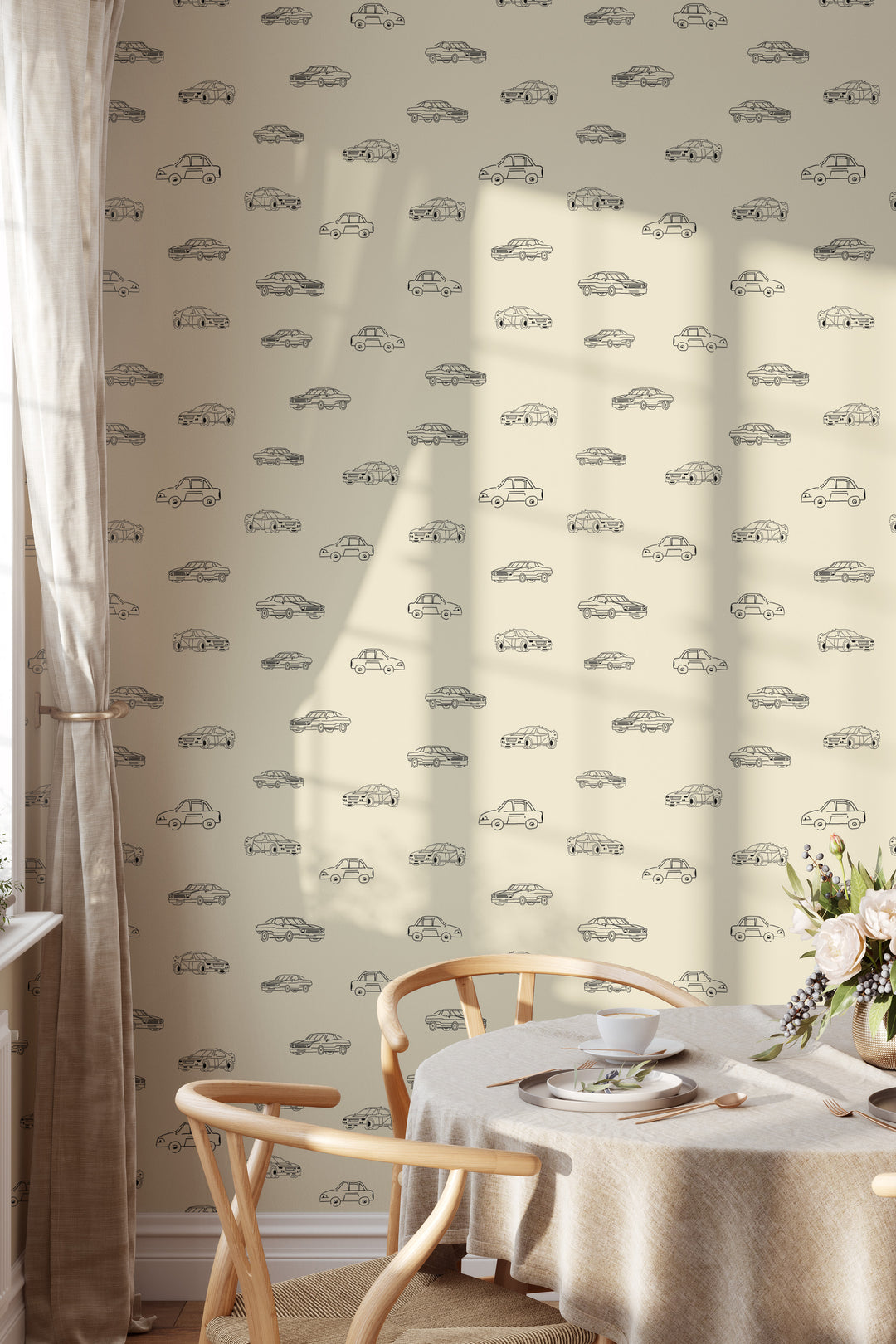 Dining room with beige vintage car wallpaper, black line art vehicle pattern, round table, and rattan chairs
