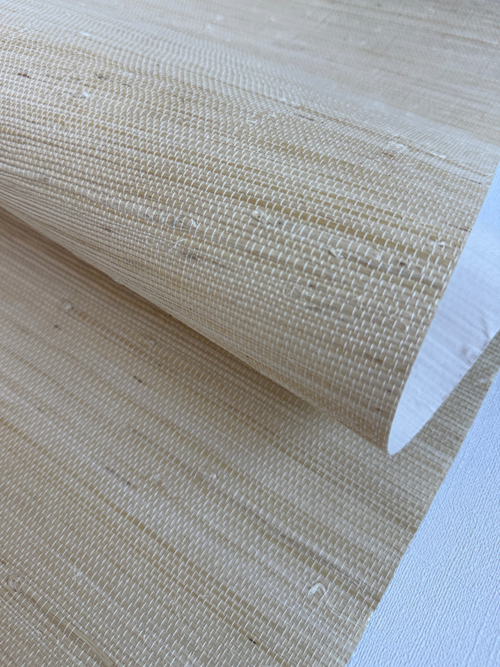 Handwoven Super Hemp 42114 natural grasscloth wallpaper in warm light straw beige, close-up showing fine horizontal weave and natural fiber knots