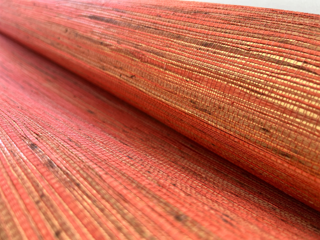 Close-up of a textured orange fabric with a subtle pattern