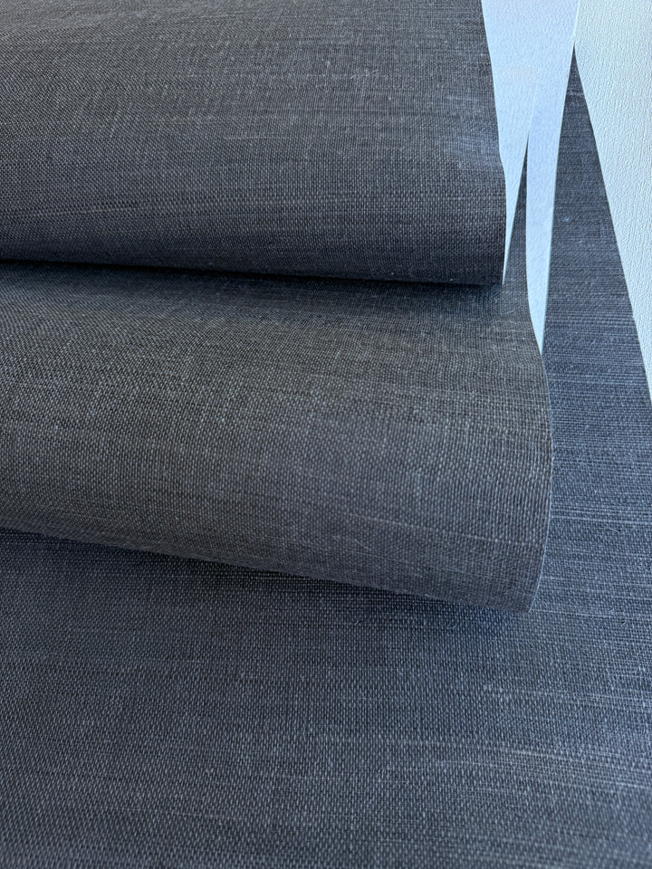 Close-up of gray sisal grasscloth wallpaper with a subtle pattern