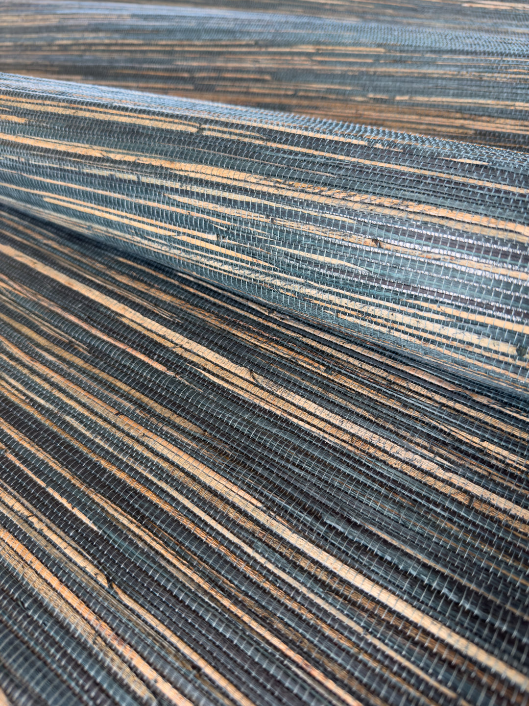 Natural Grasscloth Hemp Wallpaper painted in matte blue color 41034 Close-up of a textured blue and brown surface