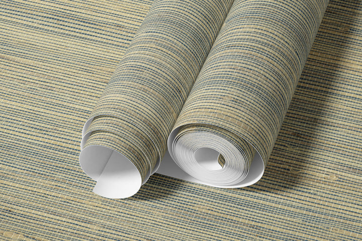 Roll of beige and navy faux hemp wallpaper with woven texture arranged in overlapping sheets showing the detailed linear pattern.