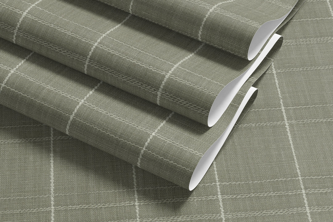 Sage gray Varrone canvas wallpaper sample showcasing a textured windowpane grid pattern with soft ivory lines and a subtle woven finish.