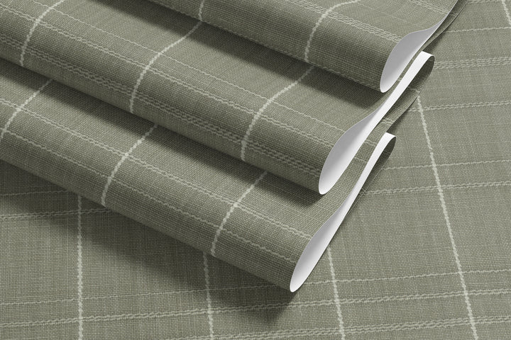 Sage gray Varrone canvas wallpaper sample showcasing a textured windowpane grid pattern with soft ivory lines and a subtle woven finish.