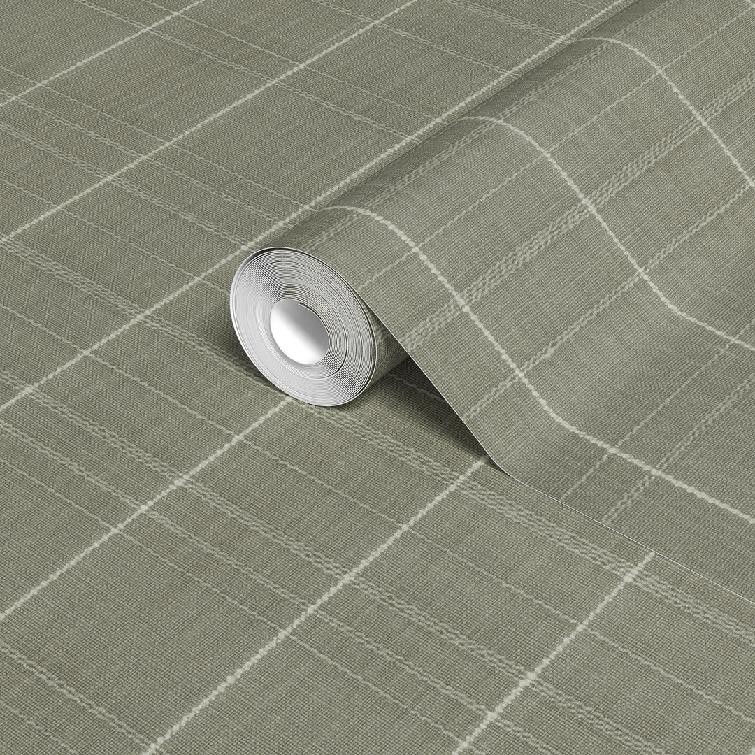 Varrone canvas wallpaper in sage gray with a textured woven finish and cream windowpane grid pattern, shown in a close-up of a rolled wallpaper sample.
